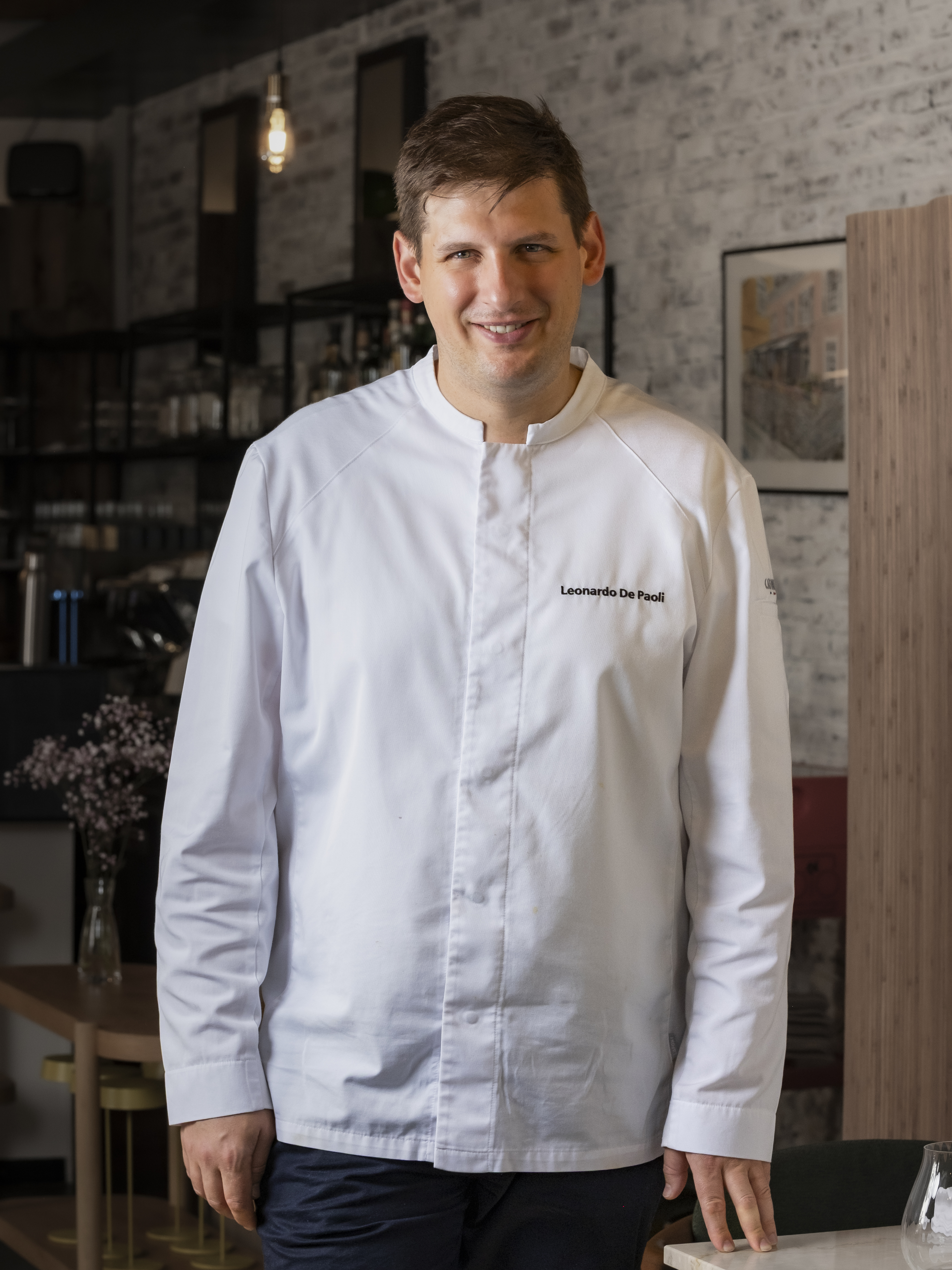 Leonardo De Paoli in his whites, standing in the OiO dining room